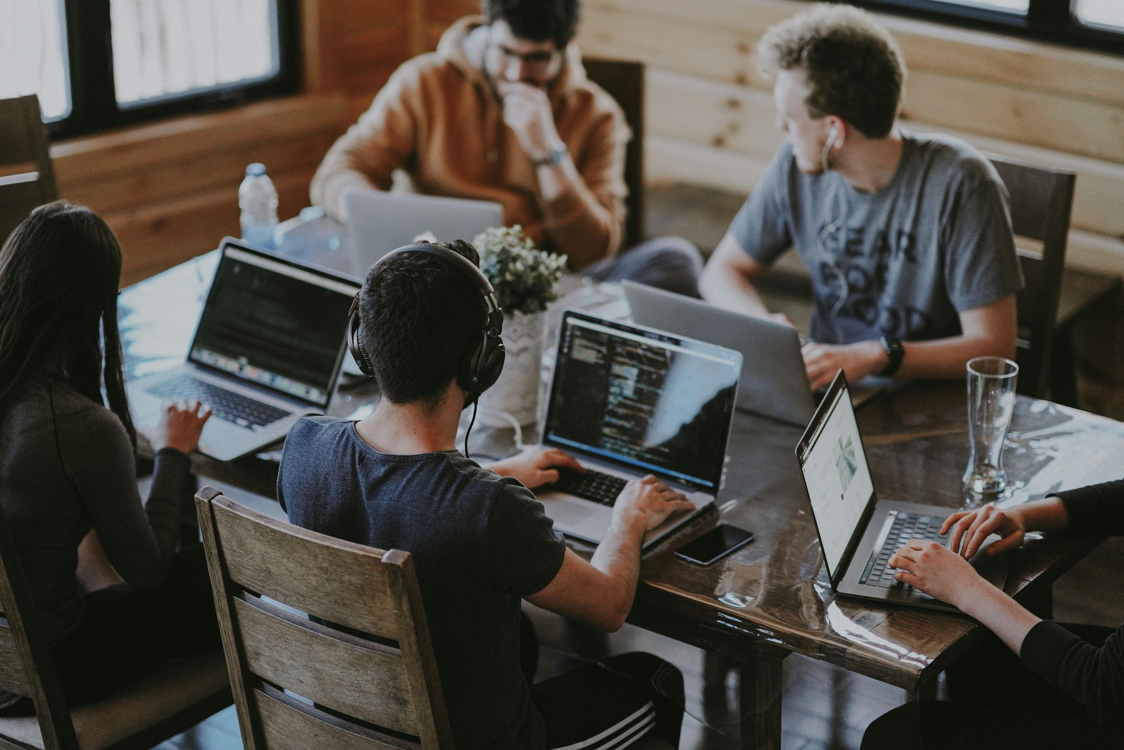 People working with laptops in a startup workspace
